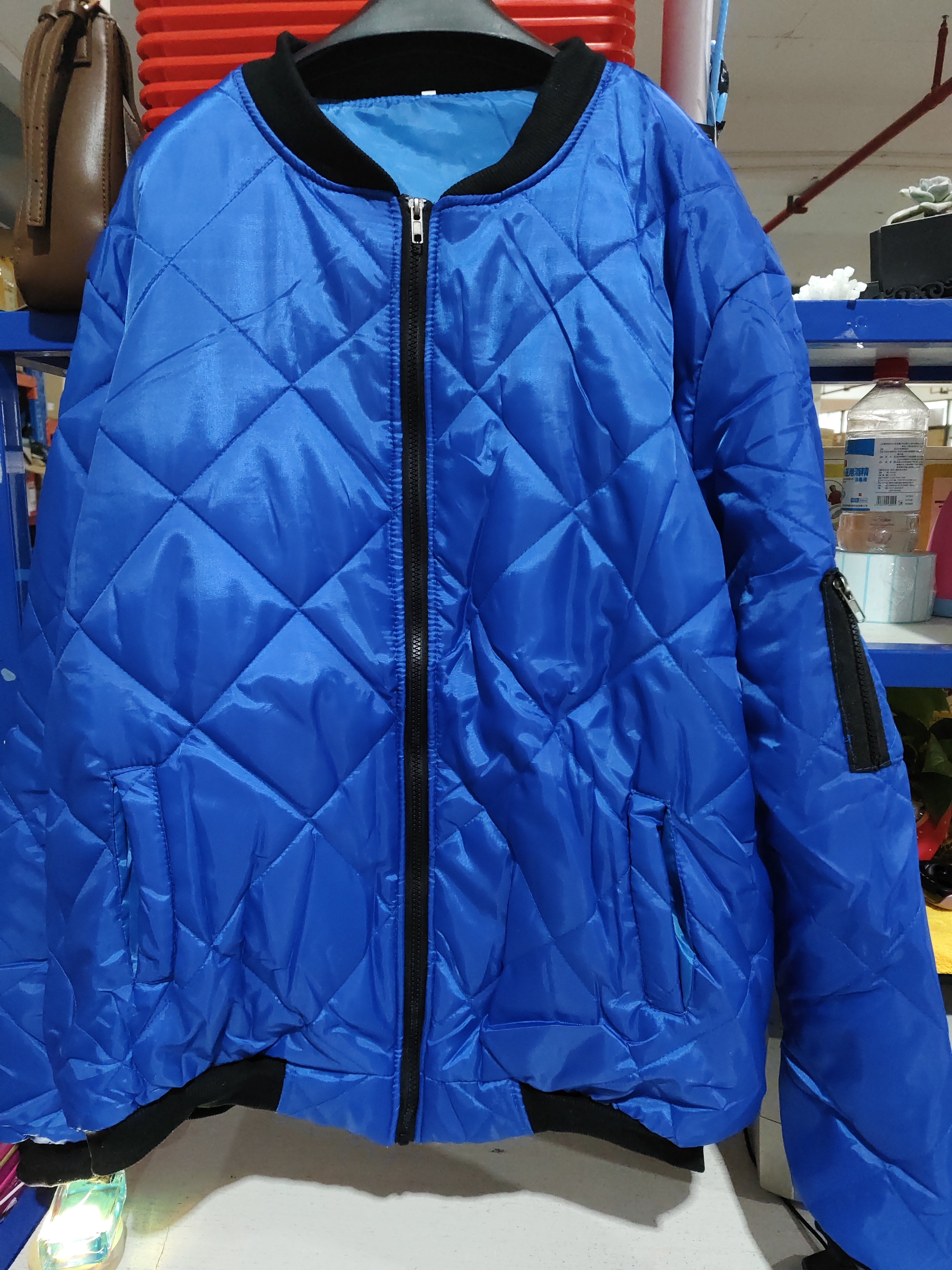 Solid color blue winter stand collar coat for men, featuring a zipper placket and loose fit for urban style.